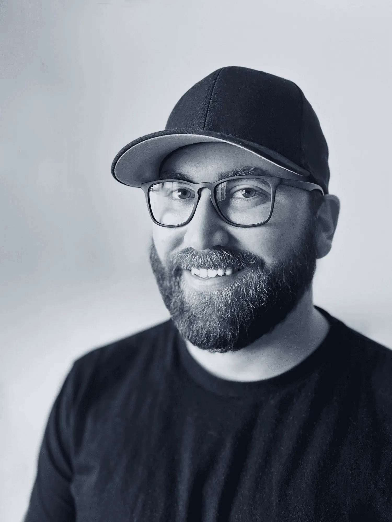 Drew Hansen in a black cap and glasses.