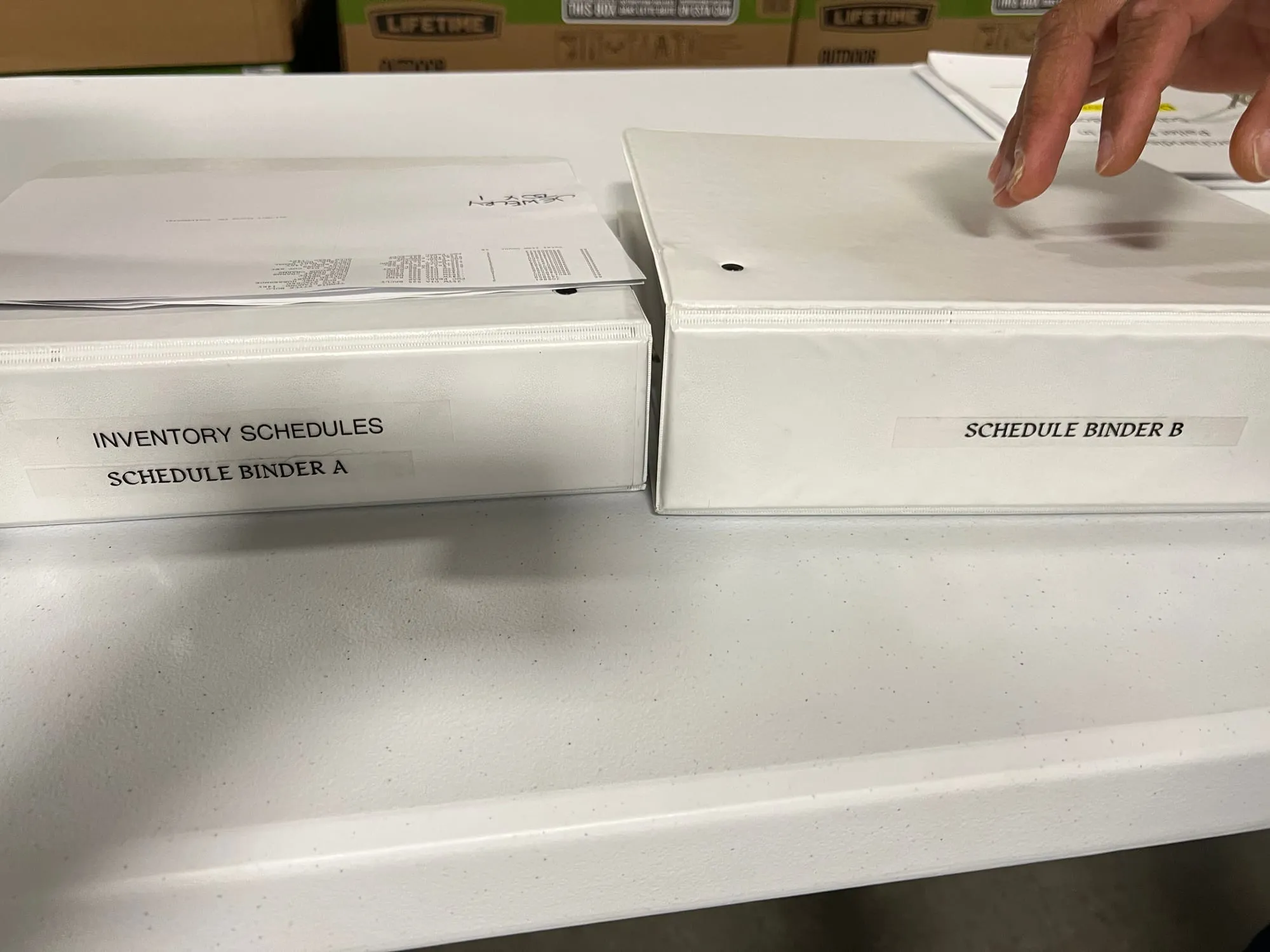 Two white binders labeled Inventory Schedules, Schedule Binder A and B.