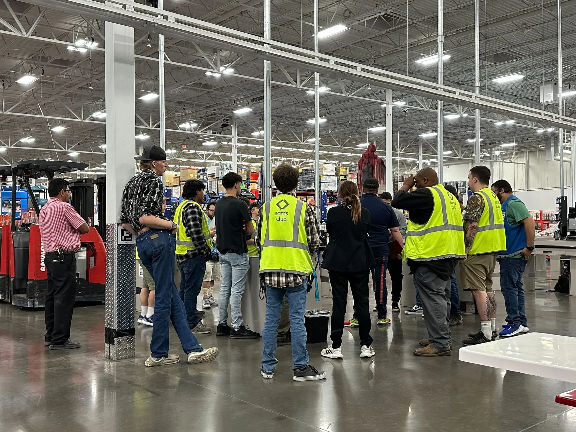 A crowd of 3rd-party counters in yellow safety vests gathered on a club floor before the count.
